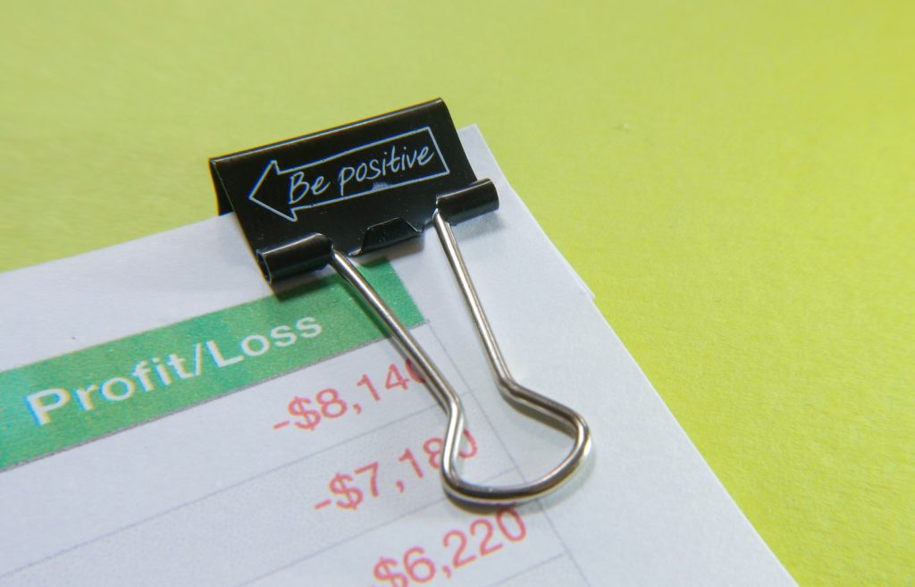 Binder Clip on Paper with Profit and Loss Statement