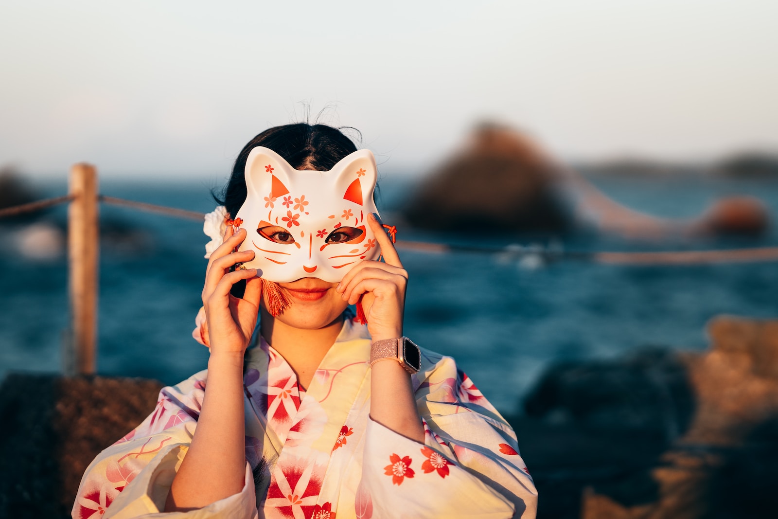a woman with a cat mask covering her face