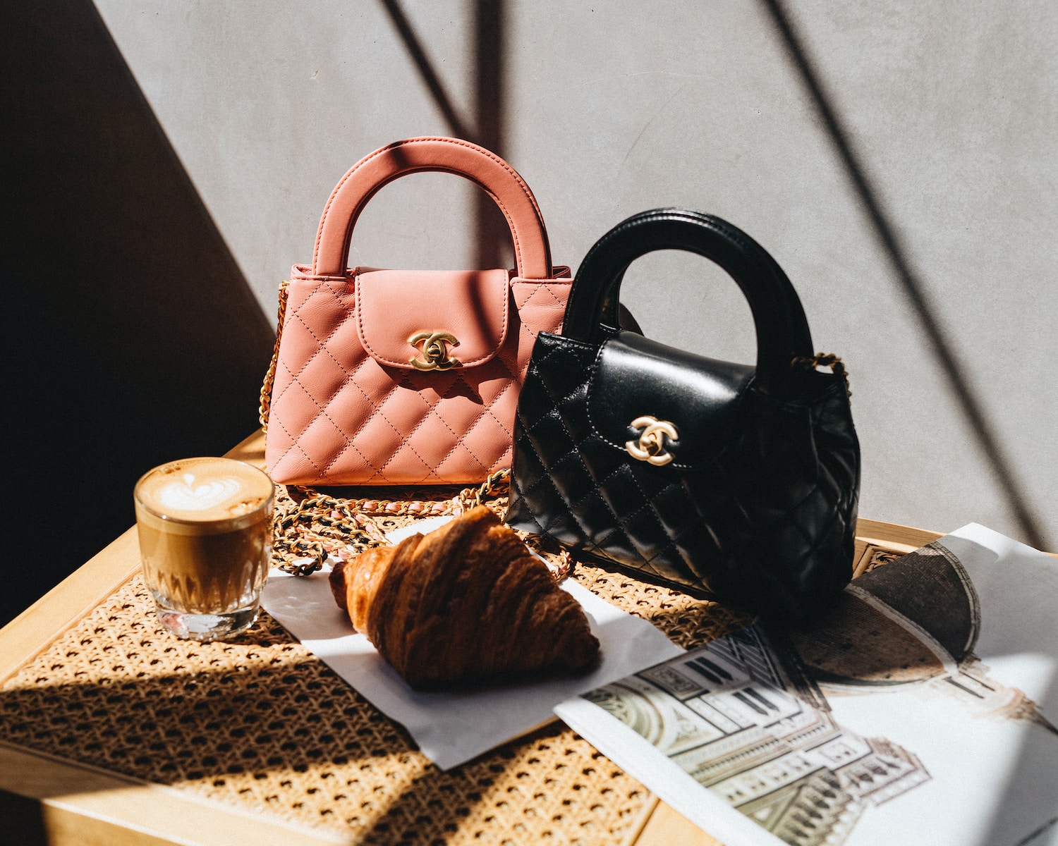 a table topped with a purse and a cup of coffee