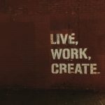 red brick wall with live, work, create. quote
