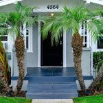 a house with palm trees in front of it