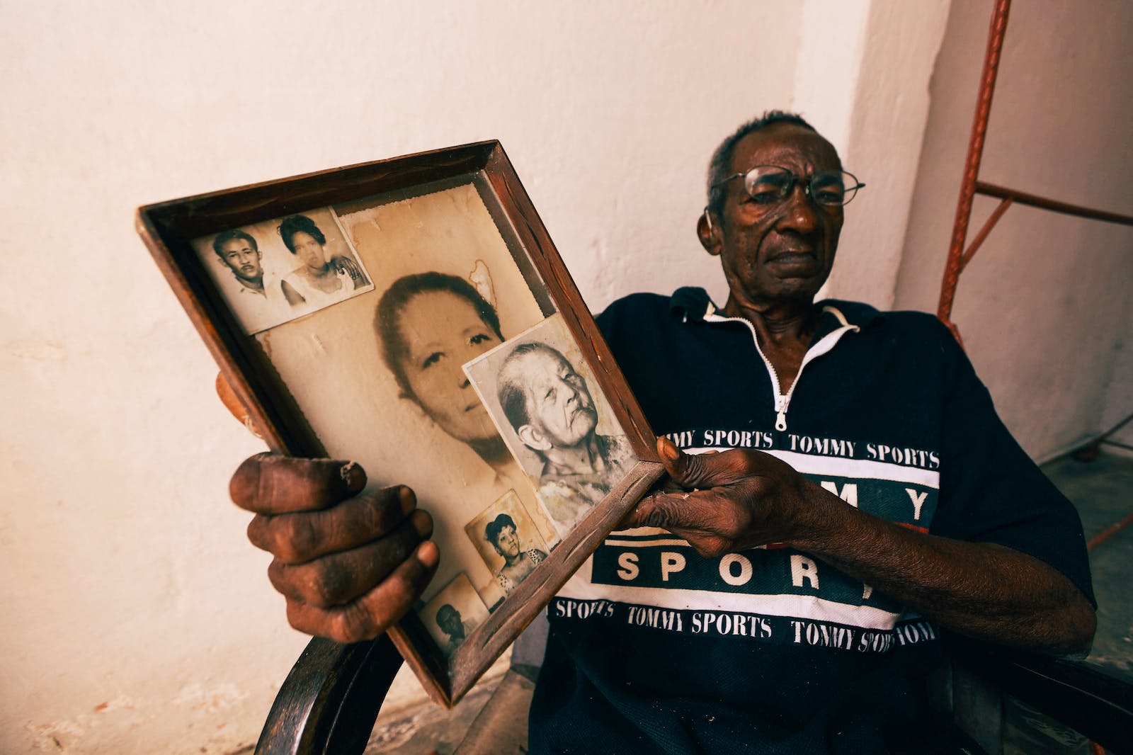 Portrait of Men with Photos in Frame