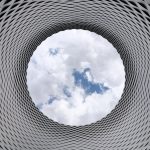 Low-angle Photography of Grey and Black Tunnel Overlooking White Cloudy and Blue Sky