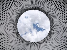 Low-angle Photography of Grey and Black Tunnel Overlooking White Cloudy and Blue Sky