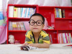 Boy Standing Near Bookshelf