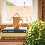Green Leafed Plant Beside Books and Mug