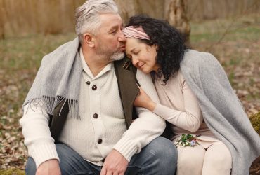 Happy senior couple hugging in autumn park