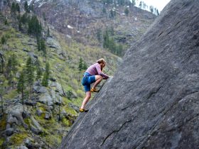 Man Climbing on Rock Mountain