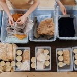 Clothing in Plastic Containers and Food in Cans on Table