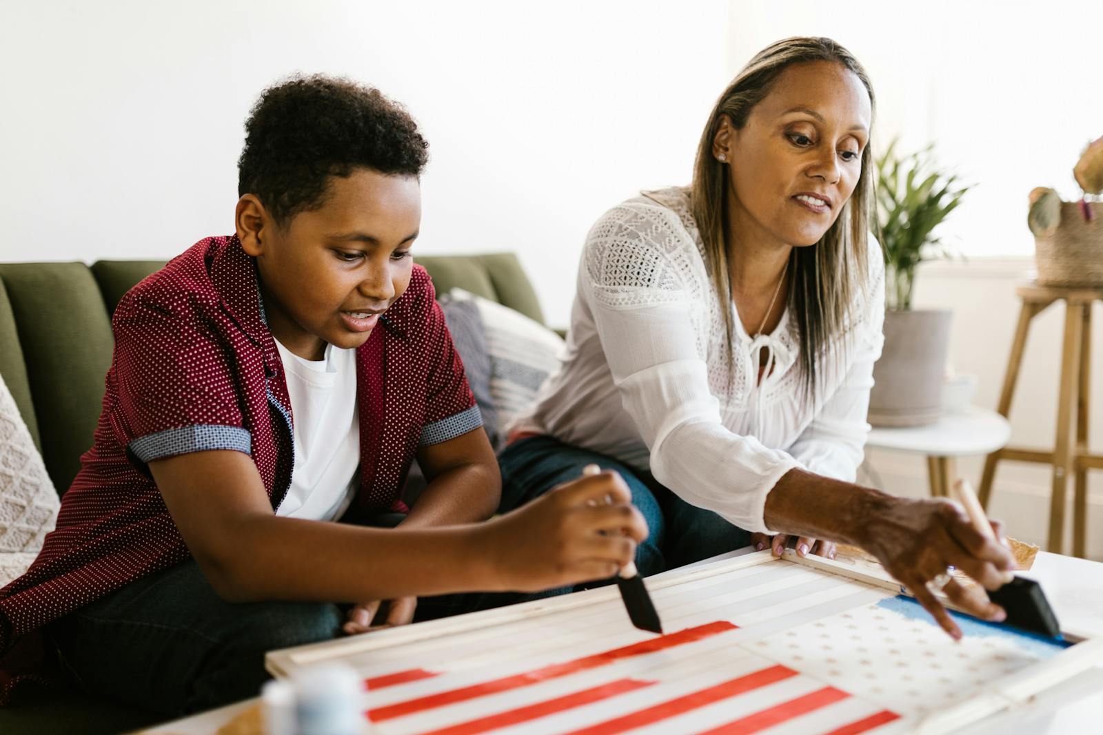 A Woman and a Boy Painting Together