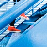 person stepping on blue stairs