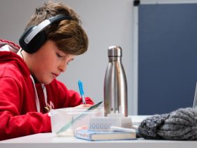 woman in red and white hoodie wearing black headphones