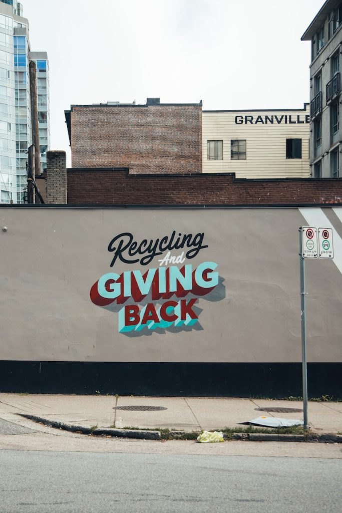 a sign on the side of a building advertising giving back