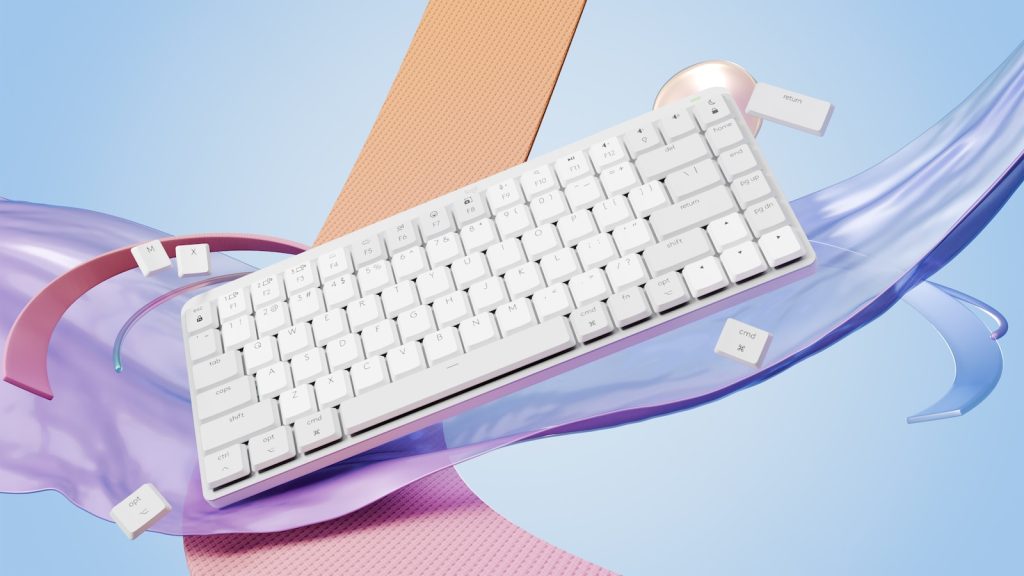 a computer keyboard sitting on top of a purple ribbon