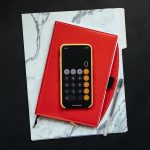 black Android smartphone on red flip case