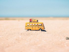 Yellow Die-cast Miniature Van on Brown Sand