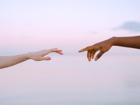 Photo Of People Reaching Each Other's Hands
