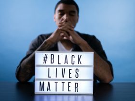 Man Behind a Black Lives Matter Sign