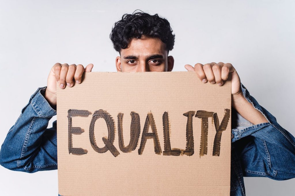 Man Holding Cardboard With Equality Text