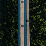 aerial photography of vehicle traveling on bridge during daytime